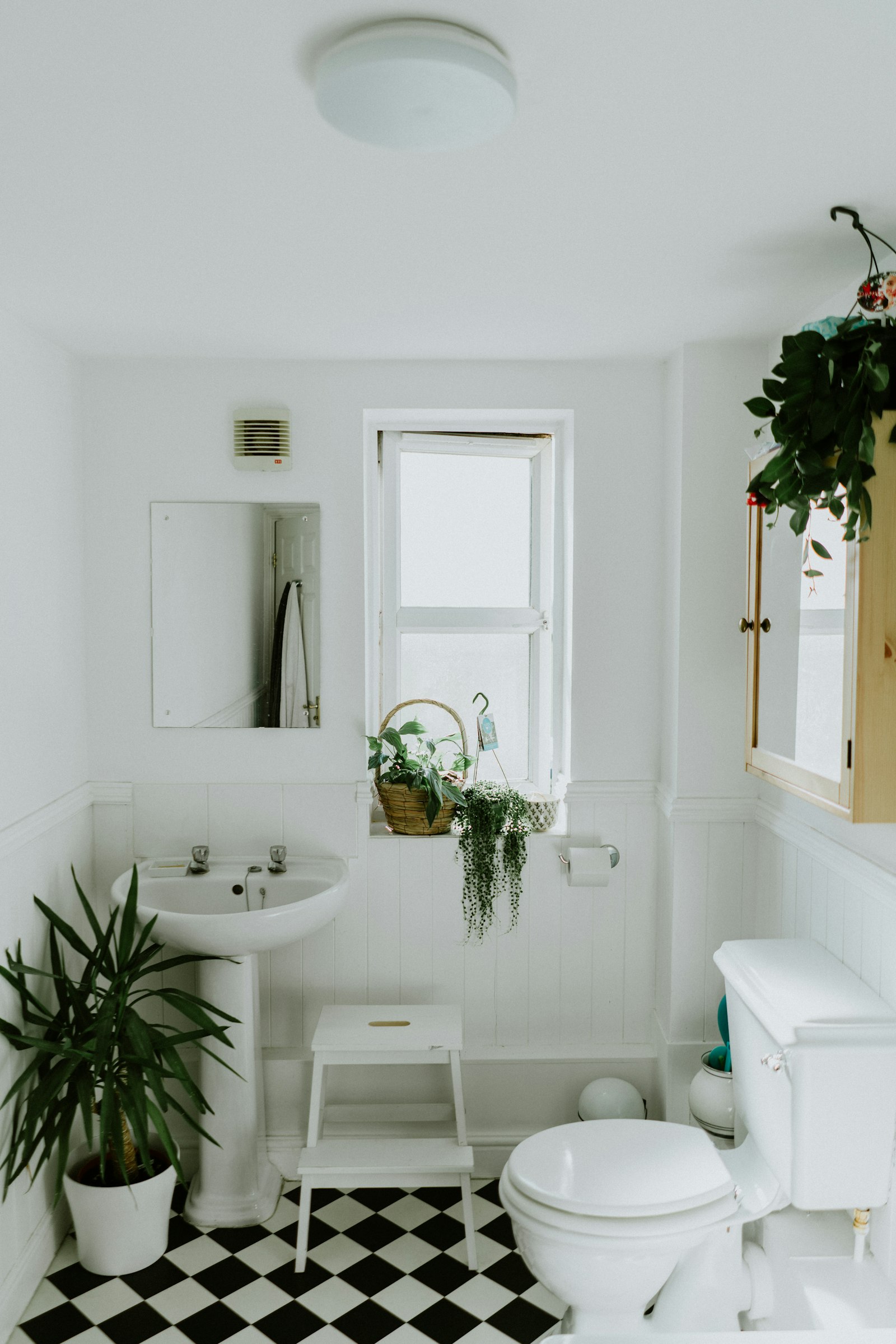 A marble bathroom with a freestanding tub and soft daylight.