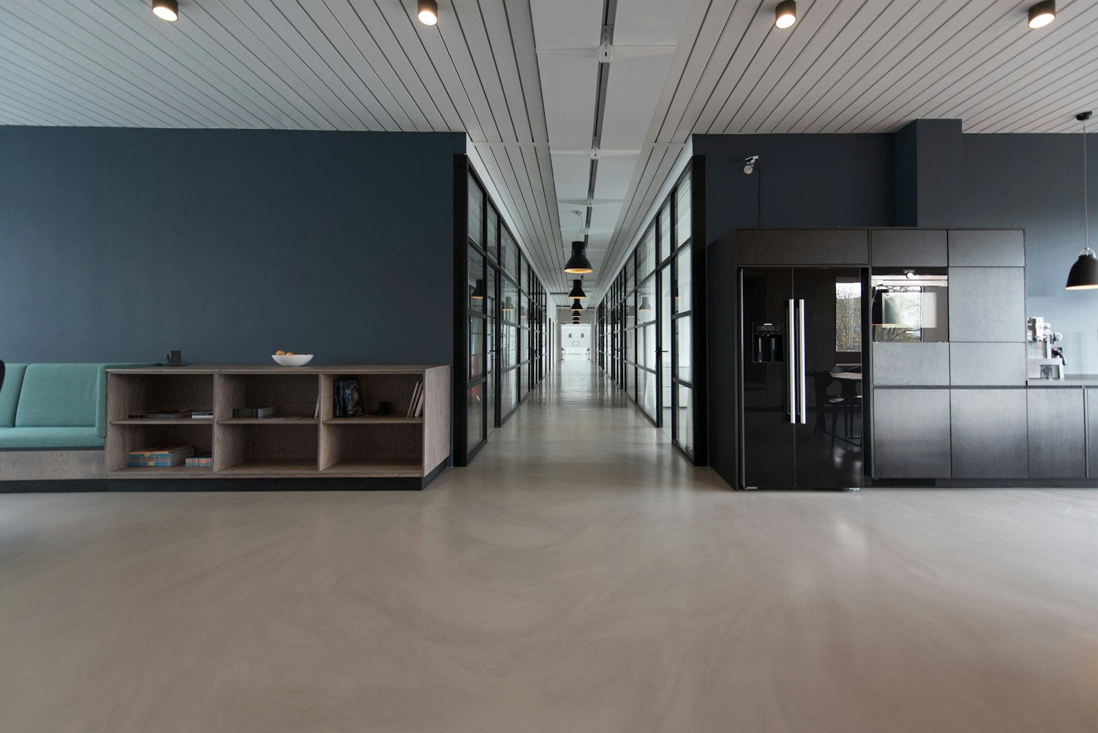 A bright office with a long table and linen-covered chairs.